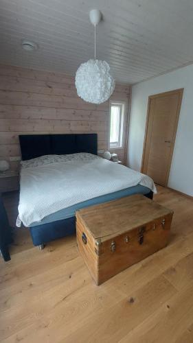 a bedroom with a large bed with a wooden floor at Kloogaranna Seaside Cottage in Kloogaranna