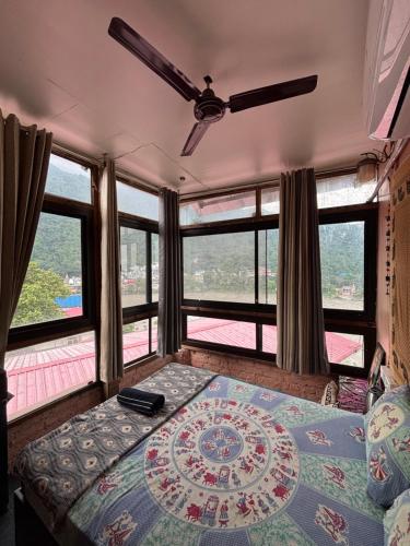 a bedroom with a bed with a large window at Om Guesthouse in Rishīkesh