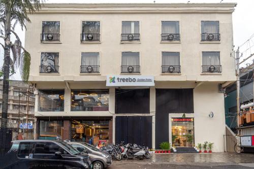 a building with motorcycles parked in front of it at Treebo Golden Palm, Civil Lines in Jabalpur