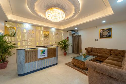 a living room with a couch and a tv at Treebo Golden Palm, Civil Lines in Jabalpur