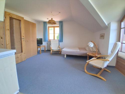 a living room with a couch and chairs in it at Ferienwohnung Stoll Helga in Burgberg