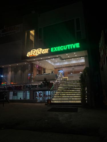 a building with a neon evacuation sign in the night at HariPriya Executive in Tuljapur