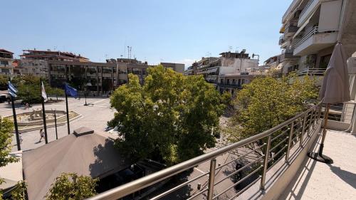 a balcony of a building with trees and buildings at Bistro 49 Luxury suites in Katerini