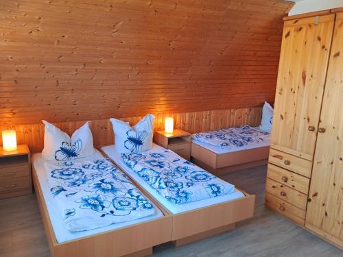 two beds in a room with blue and white at Schullandheim Sohland Spree in Auf der Wiese