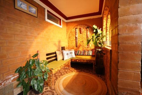 a room with a bench in a brick wall at De Rock Jungle Living Resort in Coonoor