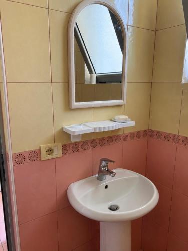 a bathroom with a sink and a mirror at Beachside Apartments Smajlaj in Velipojë