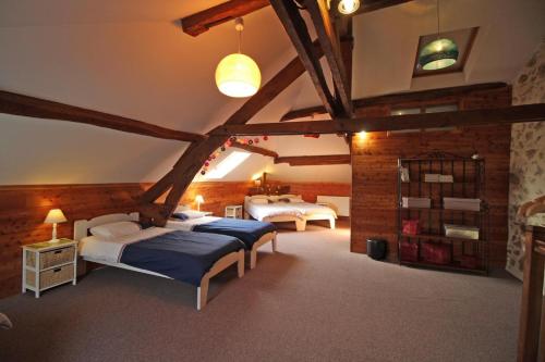 a bedroom with two beds in a attic at Fonbanoux in Flavignac