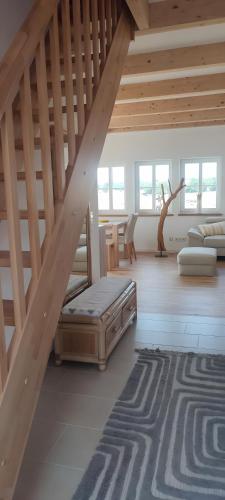 a attic room with a bed and a table at Villa Residenz am Vulkanradweg in Grebenhain
