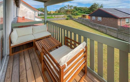 a balcony with two chairs and a table at Nice Apartment In Hanstholm With Wifi in Hanstholm