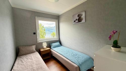 a small room with two beds and a window at Arctic Dream in Gratangen