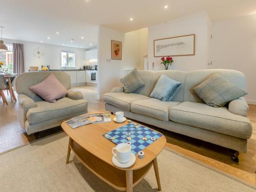 a living room with a couch and a table at Lodge 52 Una in Carbis Bay