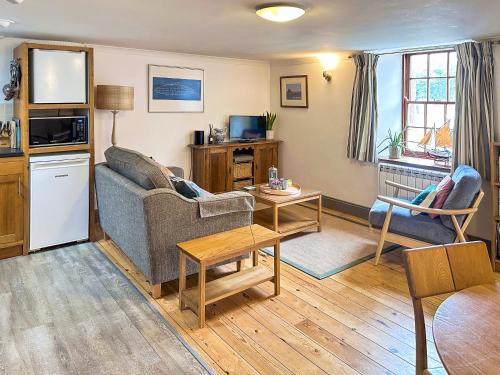 a living room with a couch and a table at Lee Cottage - E4343A in Holy Island