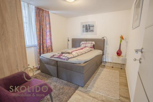 a small bedroom with a bed in a room at Casa Sunegga in Naters