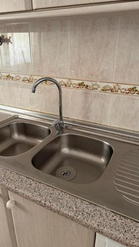 a stainless steel sink in a small kitchen at Casa da Margarida in Castro Marim