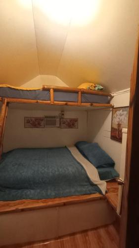 a bedroom with two bunk beds on the ceiling at Trip Nest Rentals in Dauis