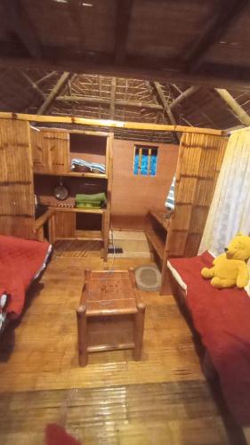 a room with two beds and a table at Trip Nest Rentals in Dauis