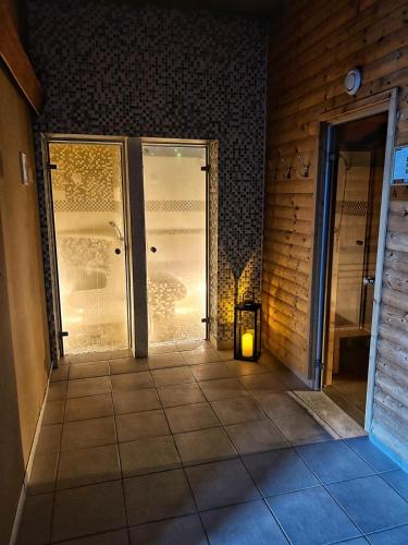 a room with a glass door with a candle in it at Hotel Jana in Přerov