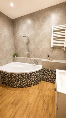 a bathroom with a large tub and a sink at Apartament Bielsko in Bielsko-Biała