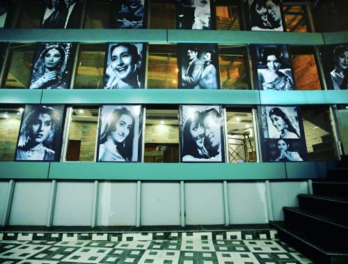 a wall with pictures of women on the side of a building at Hotel KMG Air Cooled,Zirakhpur Chandigarh ,Couple first choice ,verified hotel in Zirakpur