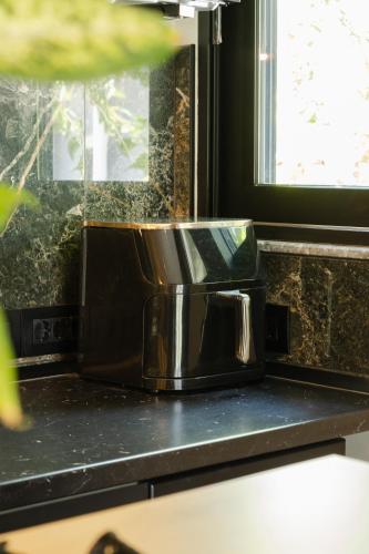 a toaster sitting on a counter next to a window at Kálos Housing - Adults Only in Kolymbia
