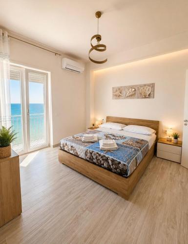 a bedroom with a bed with a view of the ocean at La Finestra Sul Mare in Torretta