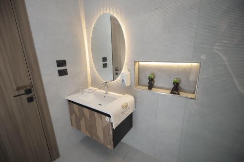 a bathroom with a sink and a mirror at weston west in 6th Of October