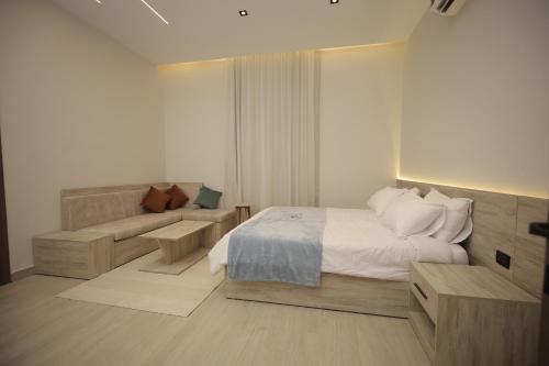 a hotel room with a bed and a couch at weston west in 6th Of October