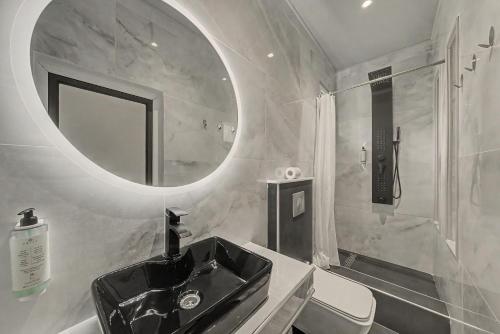 a bathroom with a black sink and a mirror at Doliva Studio 6 with private pool in Agios Gordios