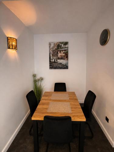 a dining room with a wooden table and chairs at Sleep Good by Adria 