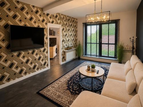 a living room with a couch and a tv at Sleep Good by Adria 