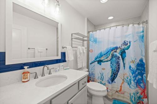 a bathroom with a sink and a shower curtain at Spacious 3BR - Sleeps 7 - King Bed - Lanai in Okahumpka