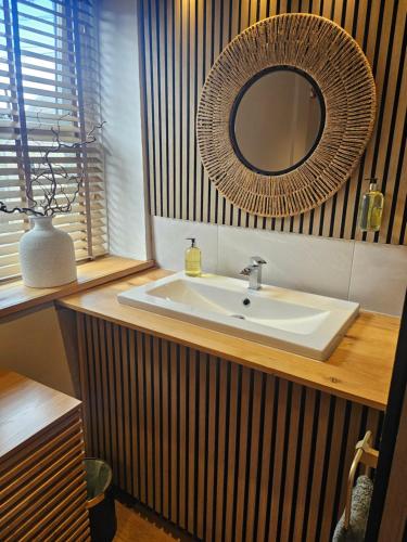 a bathroom with a sink and a mirror at Old Sun Inn in Haworth