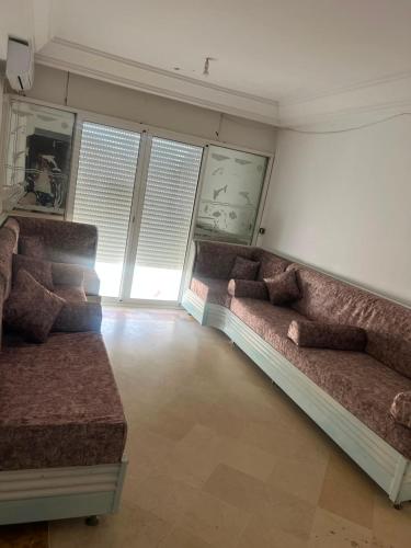 a living room with two couches in a room at Dar El vague in Hiboun