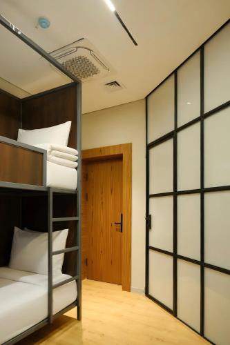 a room with two bunk beds and a door at GAIA Hostel in Türkistan