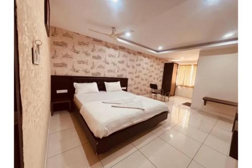 a bedroom with a bed in a room at FabHotel Udupi in Mysore