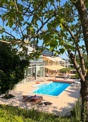 an image of a house with a swimming pool at Villa Bianca in Dalhem