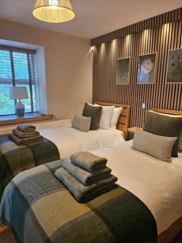 a bedroom with two beds with towels on them at Old Sun Inn in Haworth