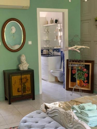 a room with a bathroom with a sink and a mirror at Les Menendos in Saint-Jean-de-Barrou