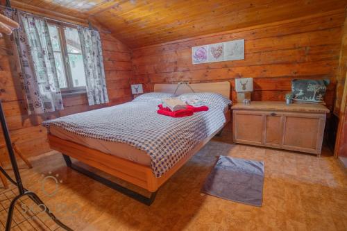 a bedroom with a bed in a wooden cabin at Cosy Chalet in Brig-Glis in Glis