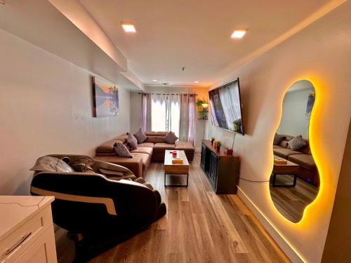 a living room with a couch and a tv at The Classic Suite: 2BR close to NYC in Paterson