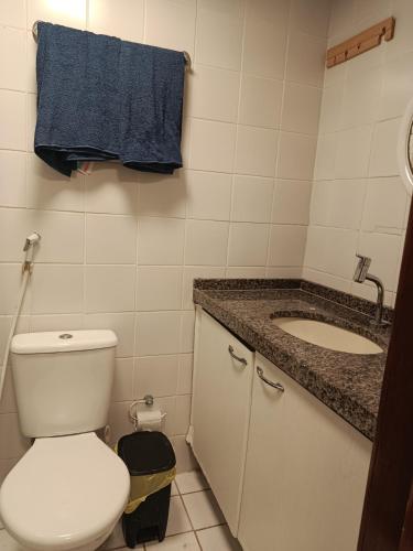 a bathroom with a toilet and a sink at Oceanview Apart Residence in Natal
