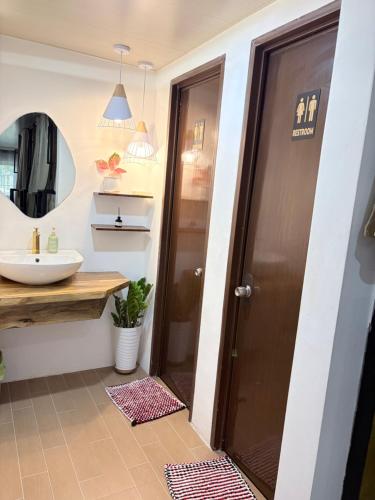 a bathroom with a sink and a mirror at La Paula Hostel in San Juan
