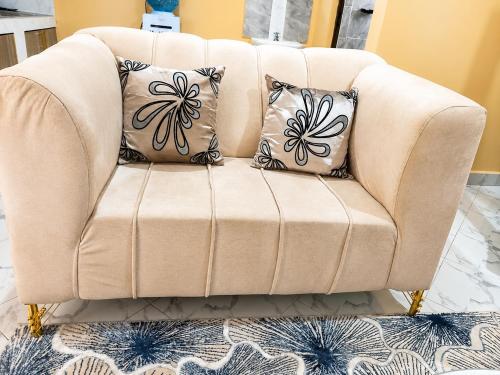 aige chair with two pillows on it in a living room at Maria VillaSTUDIO2 in Voi