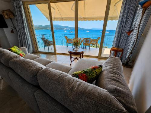 a couch in a living room with a view of the ocean at SALTY BREEZE Beachfront Apartment in Lygia