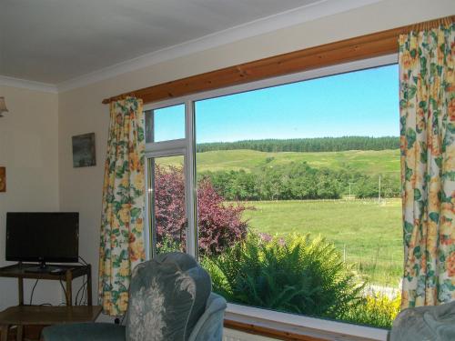 a room with a window with a view of a field at Lower Brae in Achnahanat