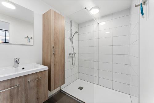 a bathroom with a shower and a sink at Barbara' s Guesthouse in Watou