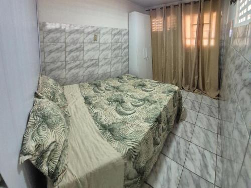 a bedroom with a bed in a room at Flat Centro Rota Cachoeira in Bonito