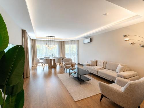 a living room with a couch and a table at Utopia Suite Residence1 in Burunabat