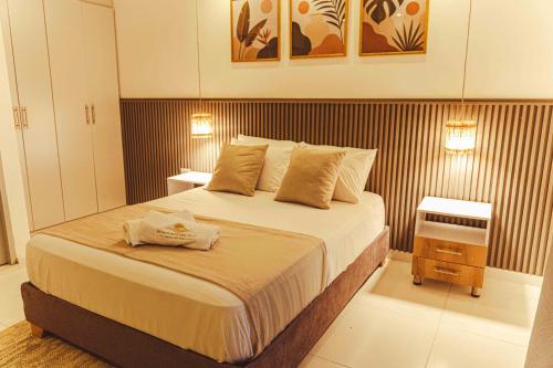 a bedroom with a bed with two towels on it at Horizonte del Mar Hotel Boutique in Santa Marta