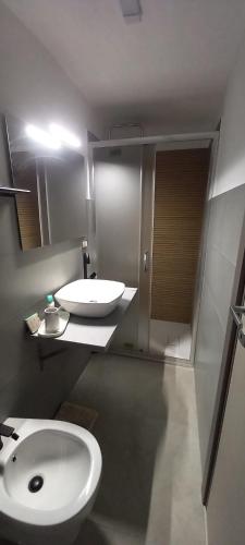 a bathroom with a white sink and a toilet at B&B "Arberia"casa vacanze in San Giorgio Albanese